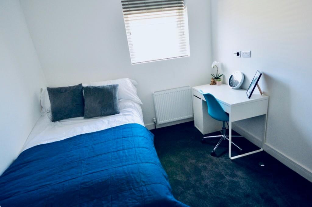 A bright and inviting double bedroom featuring ...