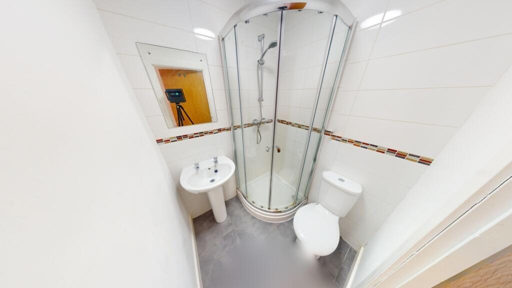 A modern and clean bathroom featuring a curved ...