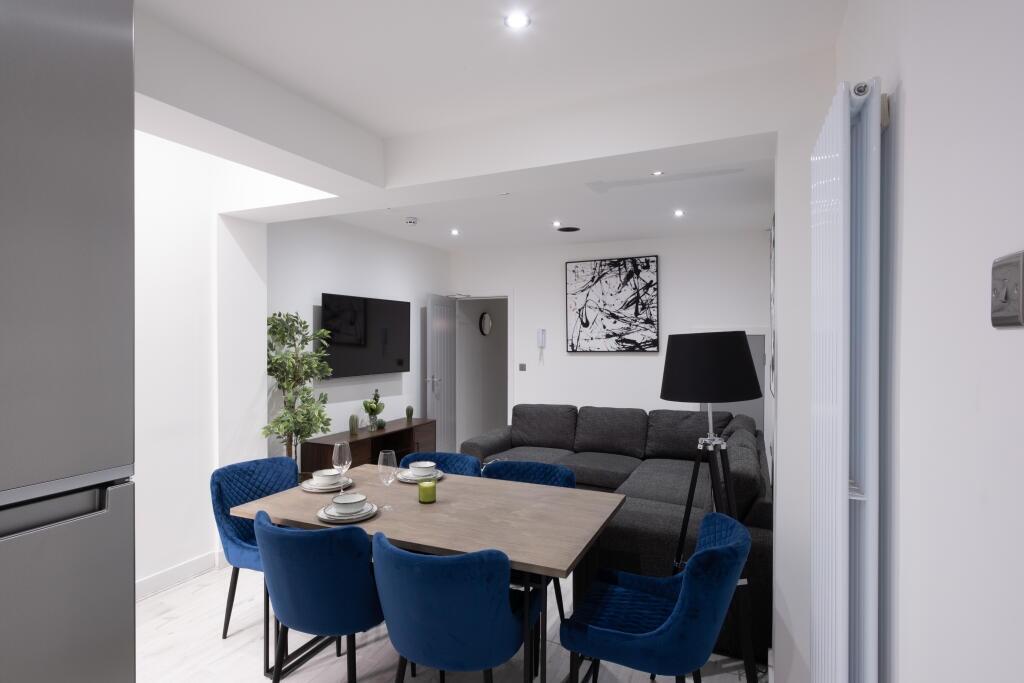 This stylish living room features a spacious la...