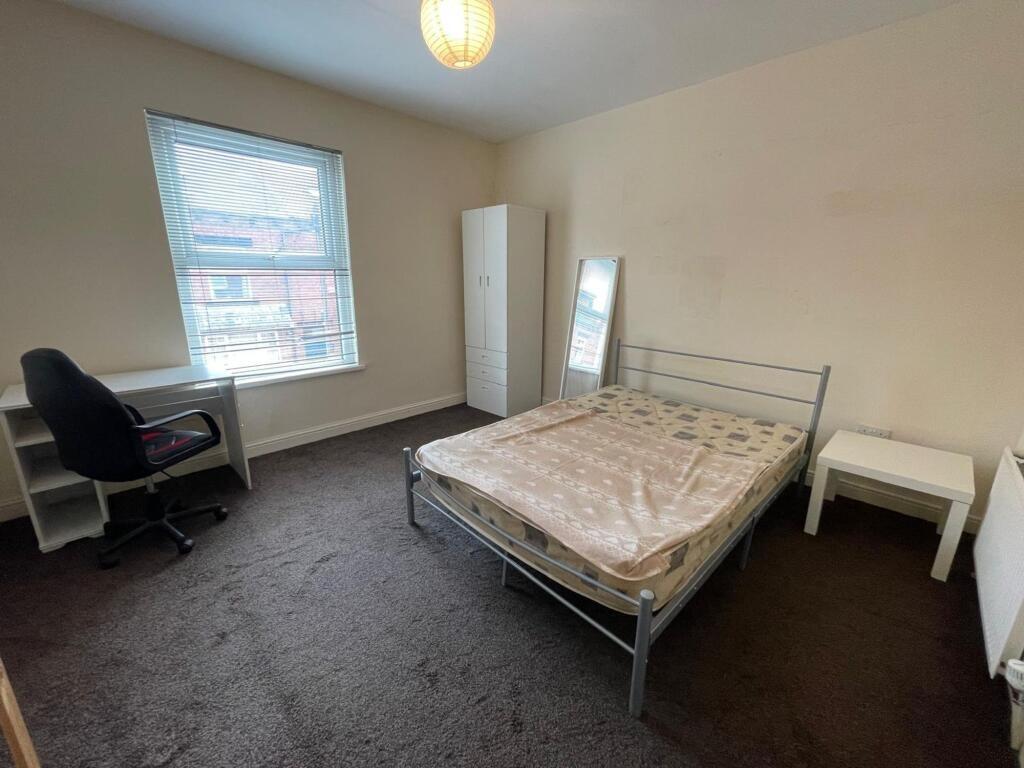 Bright and simple double bedroom featuring a la...