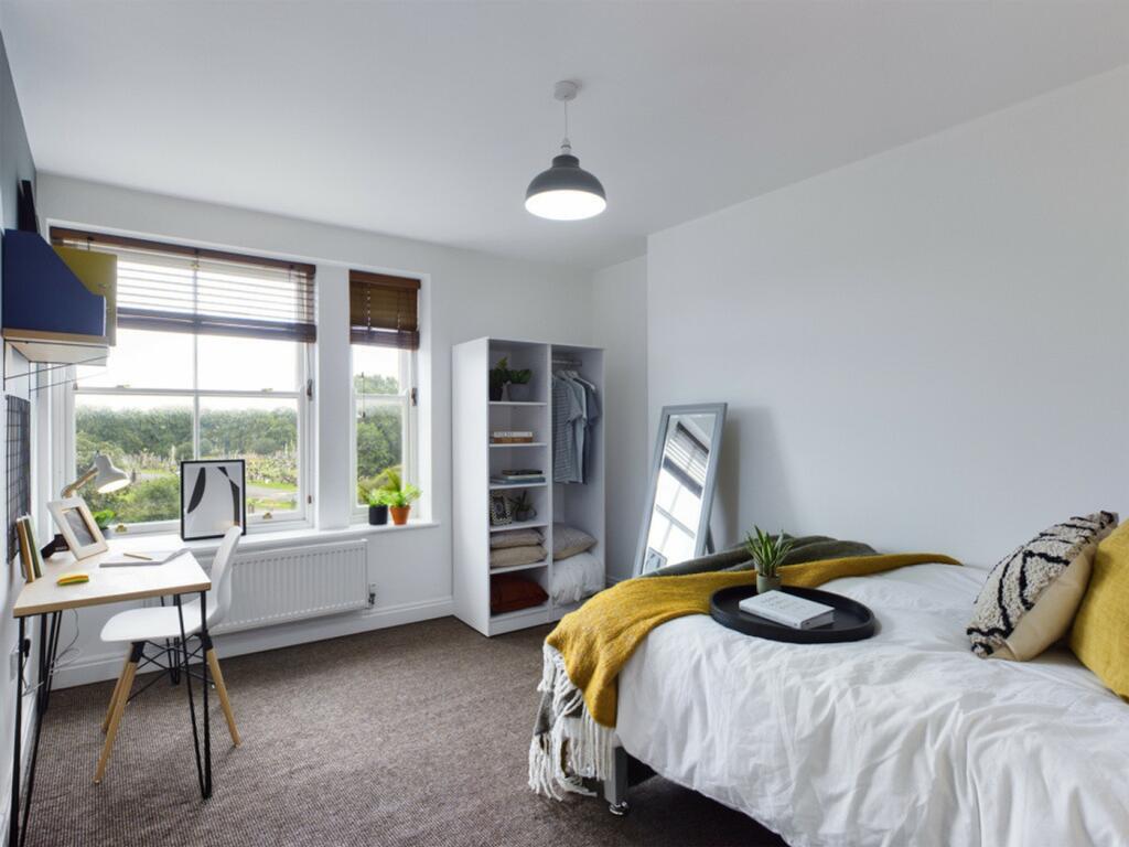A bright and inviting double bedroom with a mod...