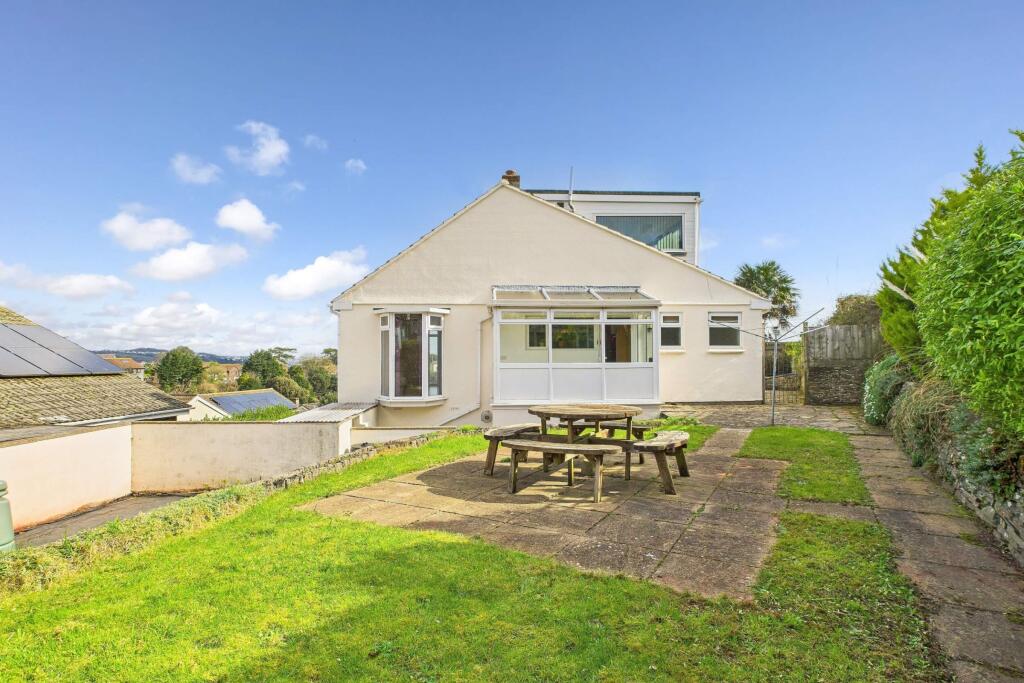 Rear garden with patio, lawn, and house exterior v
