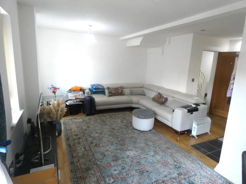 Spacious and inviting living room featuring com...