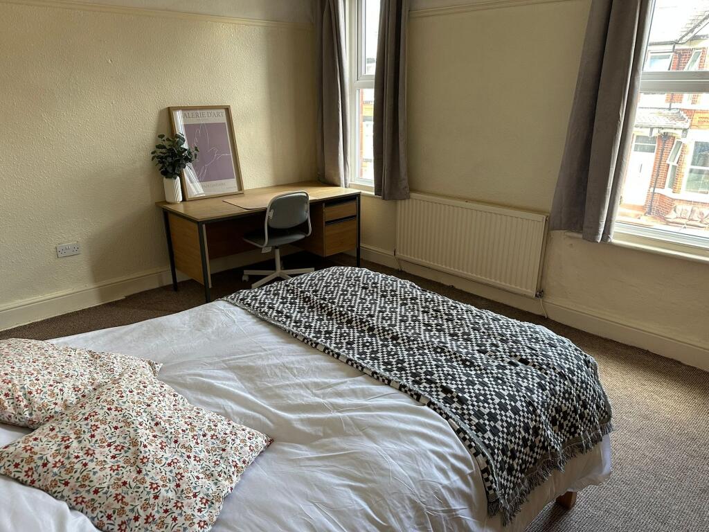 Bright and inviting master bedroom showcasing a...