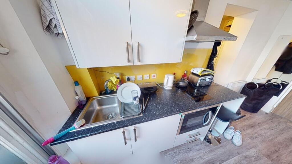 This modern kitchen features a sleek design wit...