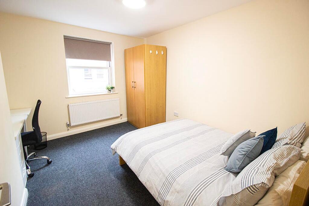 A cozy double bedroom featuring ample natural l...