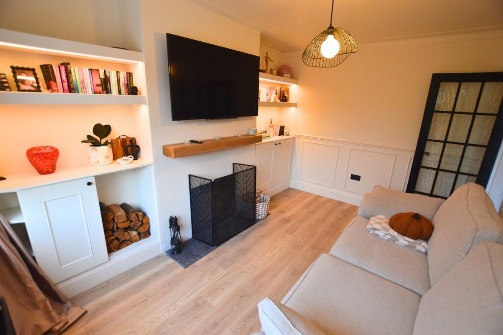 A cozy living room featuring a comfortable beig...