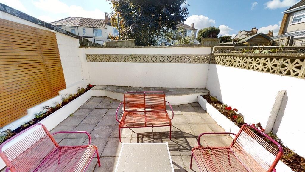 Bright and inviting private garden patio featur...