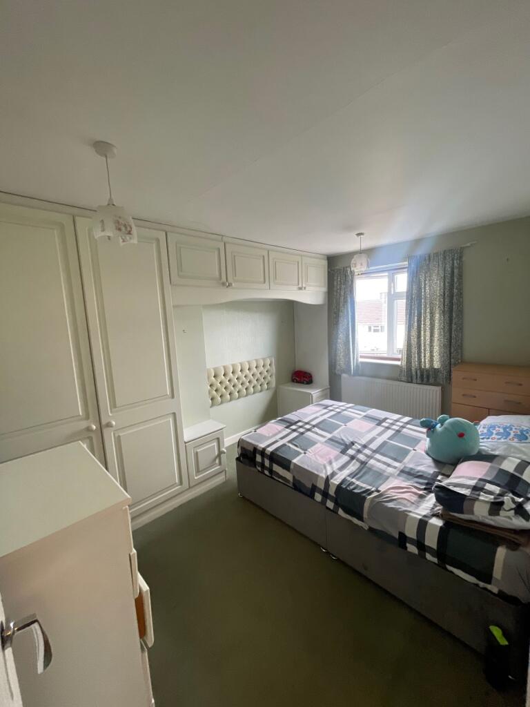A cozy double bedroom featuring built-in white ...