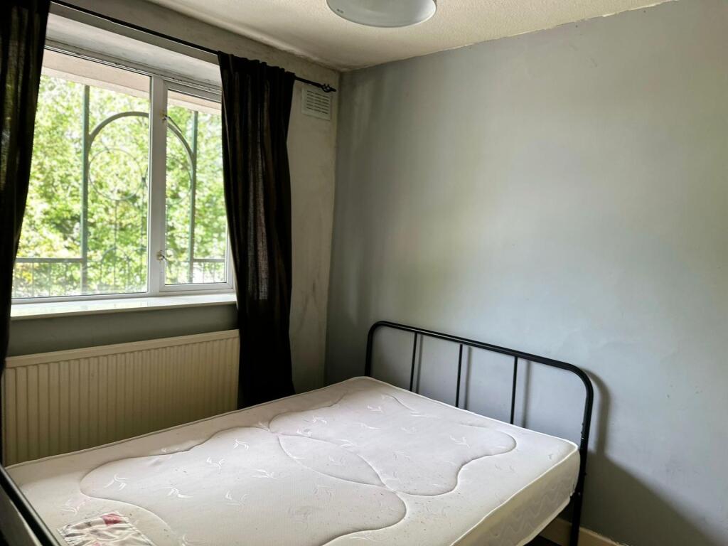 A bright and clean double bedroom featuring a l...