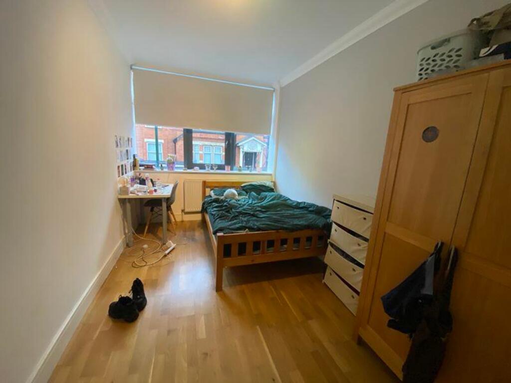 A bright and inviting double bedroom with ample...