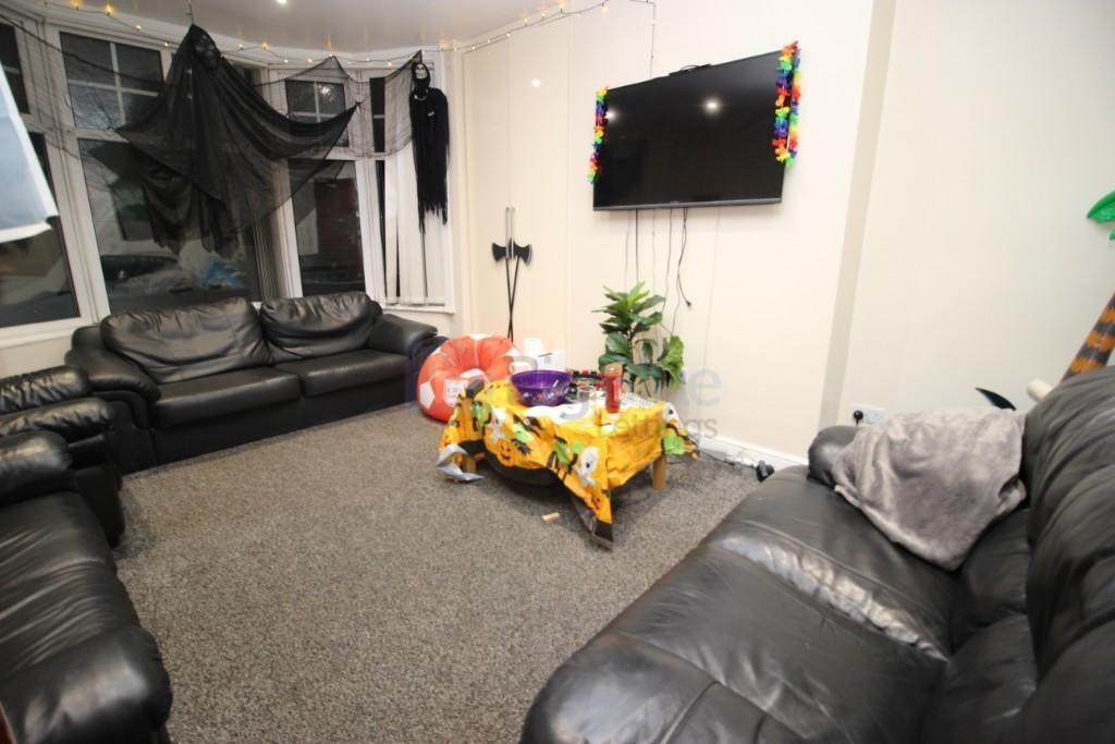 Cozy living room featuring black leather sofas ...