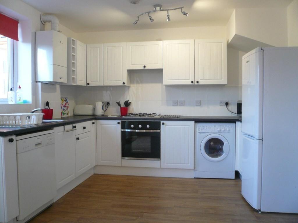 A bright and spacious kitchen featuring modern ...