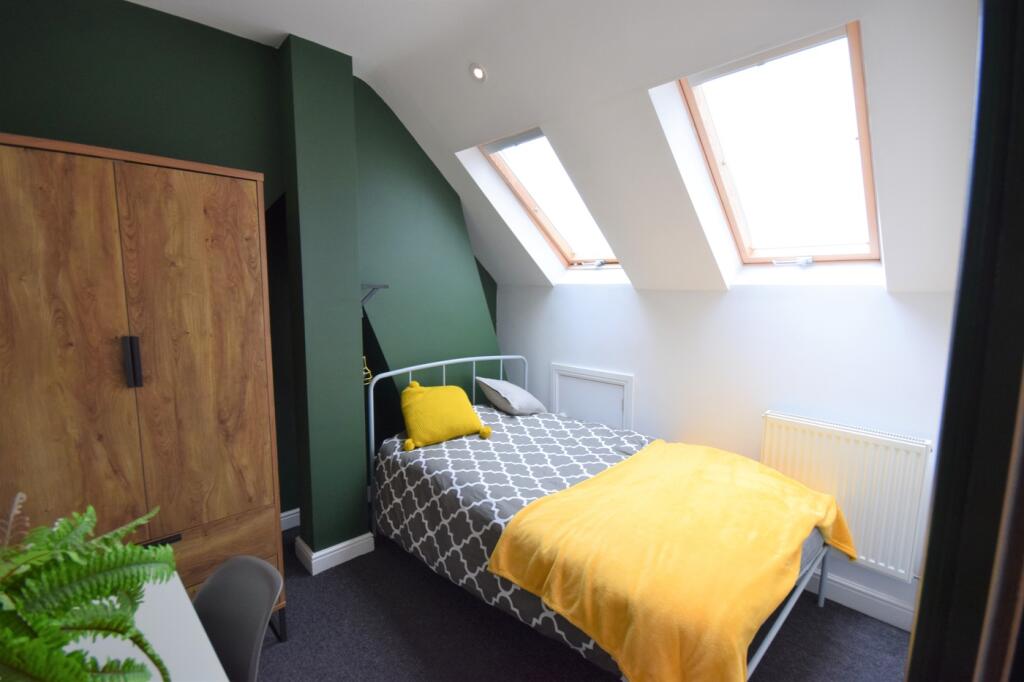 A bright and inviting double bedroom featuring ...
