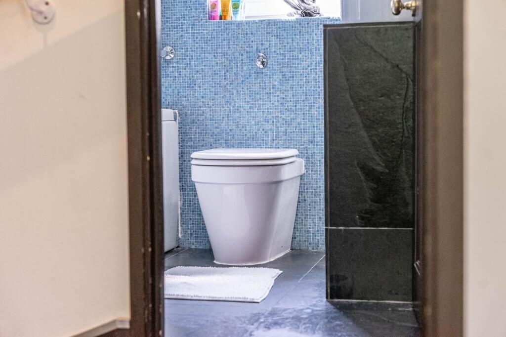 Bright and clean single toilet area with modern...