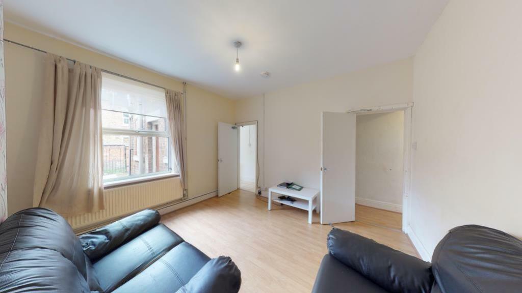 Bright and inviting living room with ample natu...