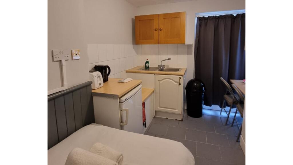 A compact and well-maintained kitchenette, perf...