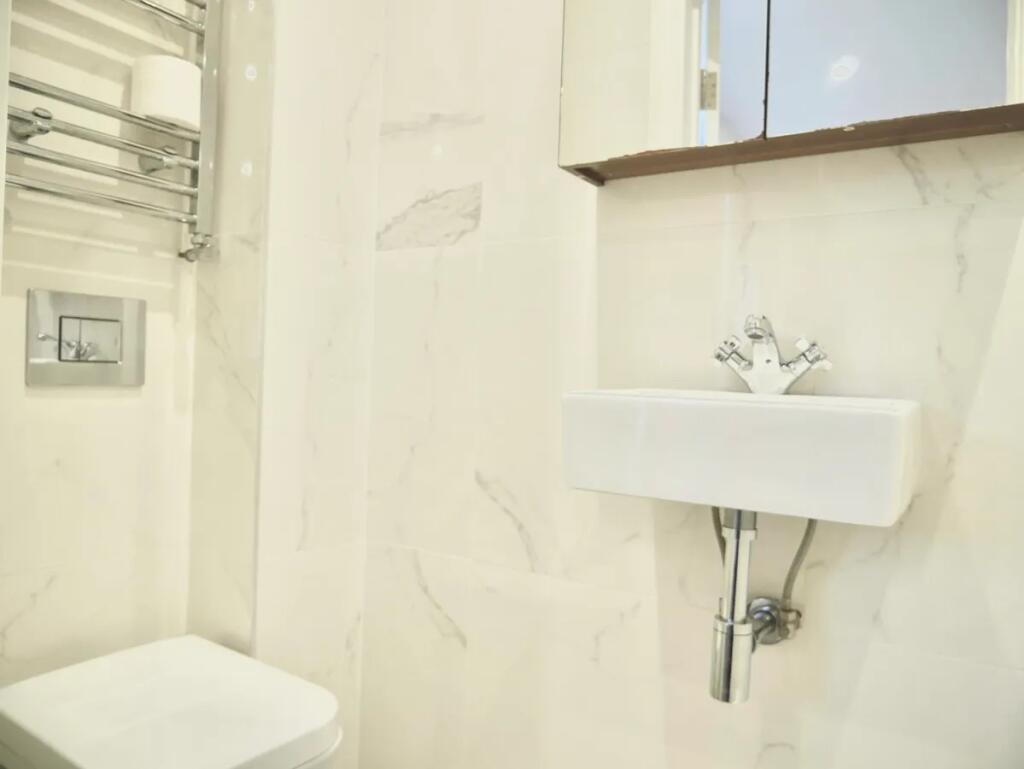 Bright and pristine single toilet with modern f...