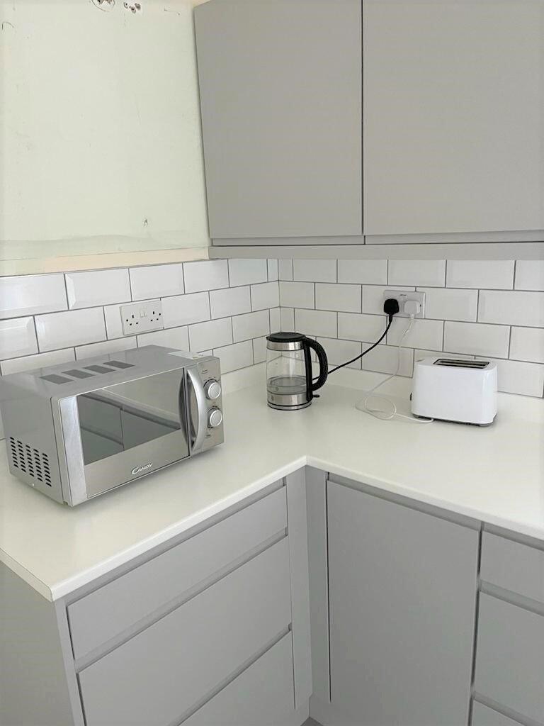 A modern and tidy kitchen corner featuring slee...