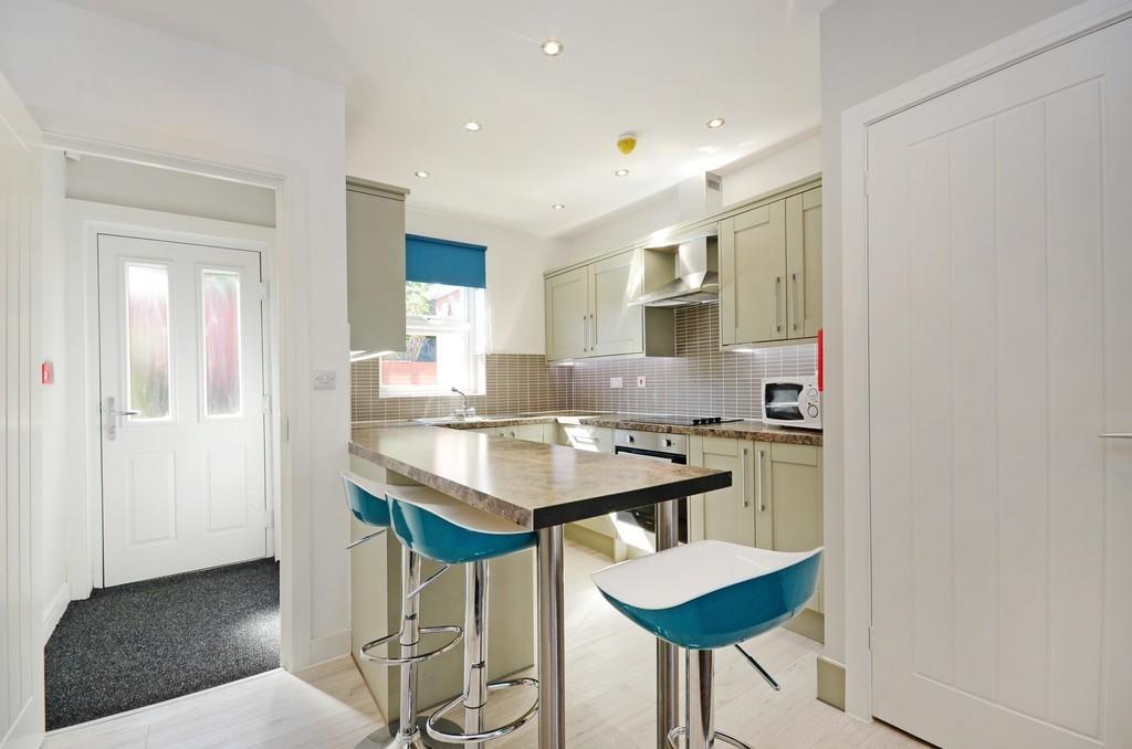 Bright and modern kitchen featuring a breakfast...