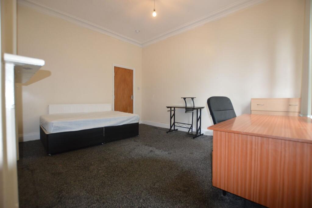 A simple and clean single bedroom featuring a s...