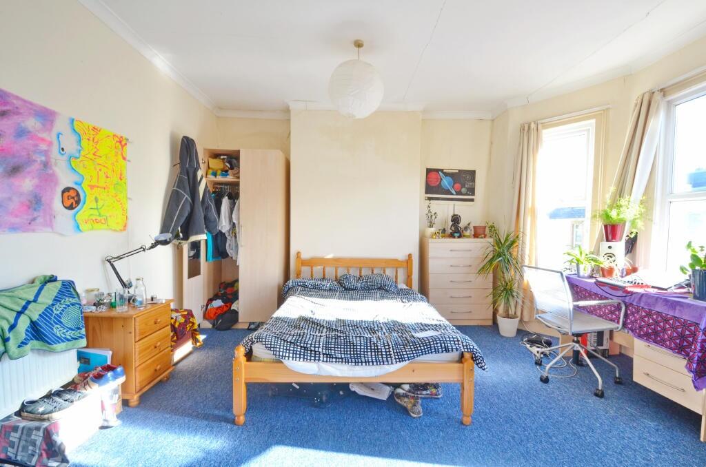 Bright and spacious master bedroom featuring a ...