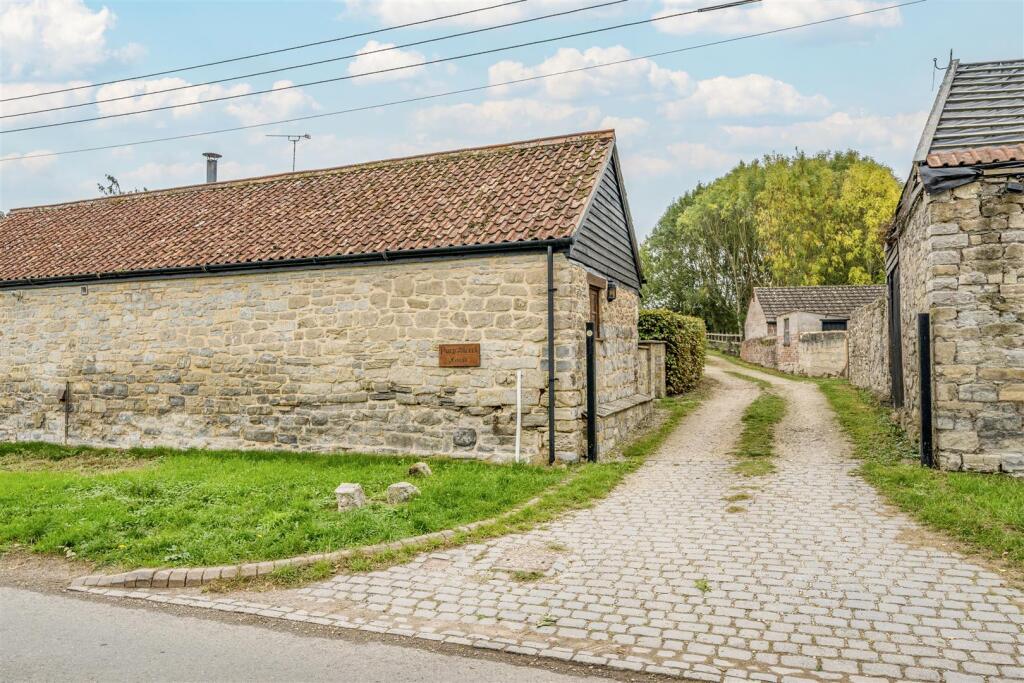 Entrance from village road to shared driveway