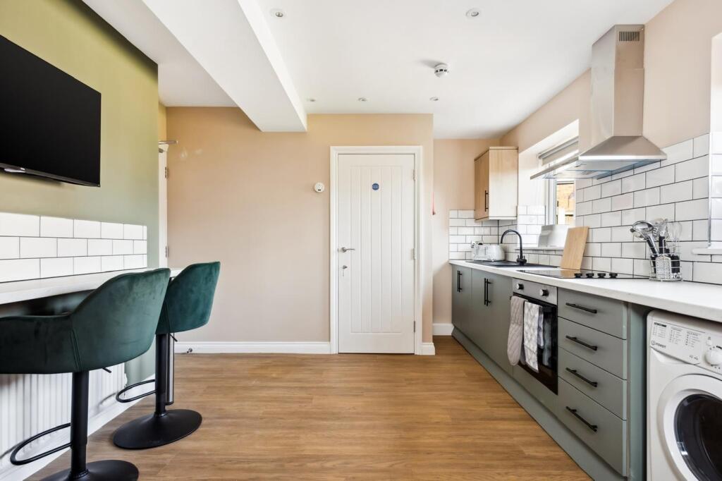 This stylish kitchen features modern appliances...