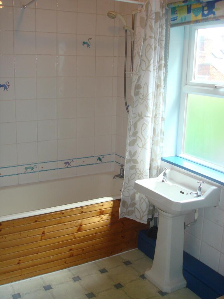 A bright and well-maintained bathroom featuring...