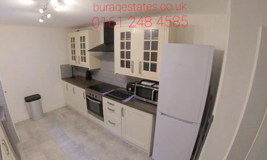 Bright modern kitchen with fitted cabinets, int...