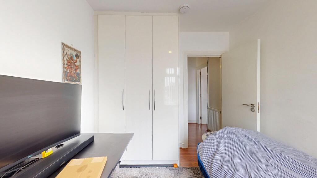 A clean and tidy single bedroom featuring a com...