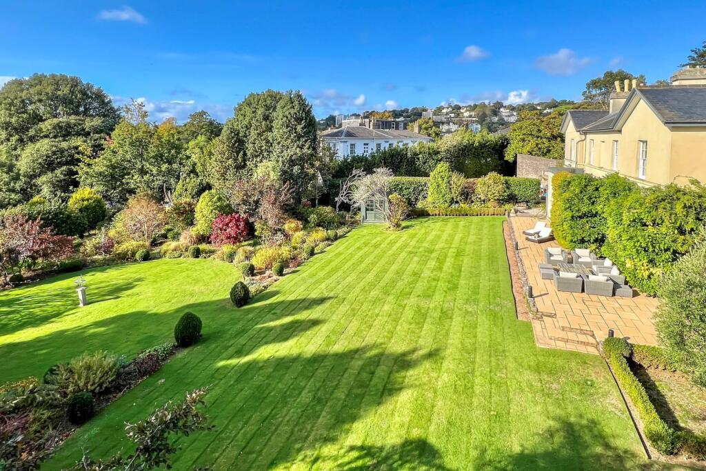 Expansive lawns with paved terrace