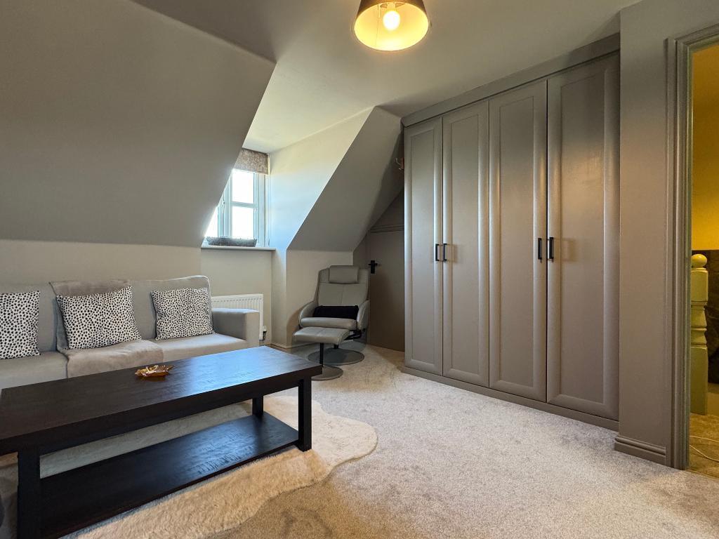 Sofa area and wardrobes to Bed 1