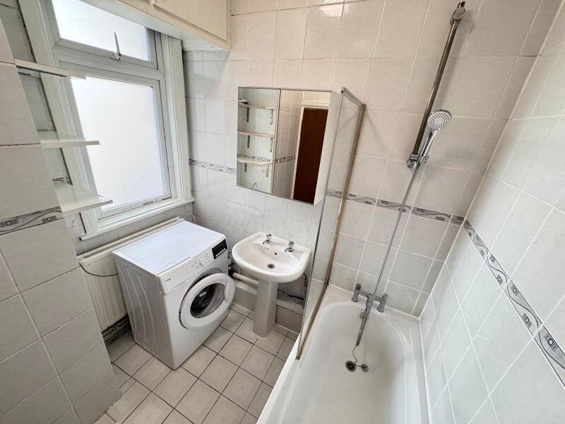 Bright and clean bathroom suite featuring a sta...