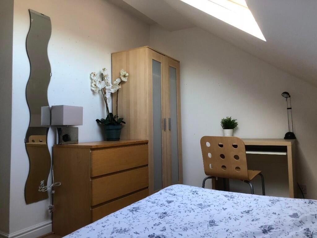 Bright and modern master bedroom featuring a co...