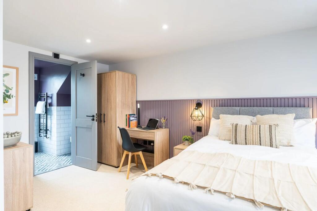 Bright, contemporary bedroom with a comfortable...