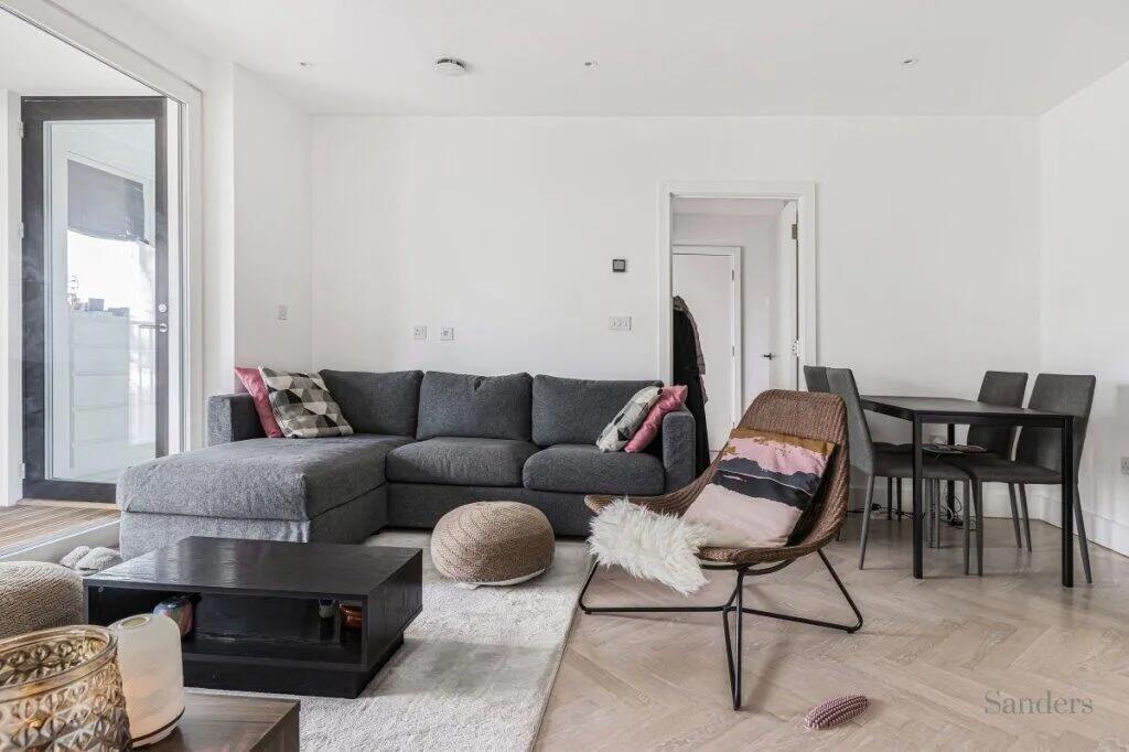 A modern living room featuring a comfortable gr...