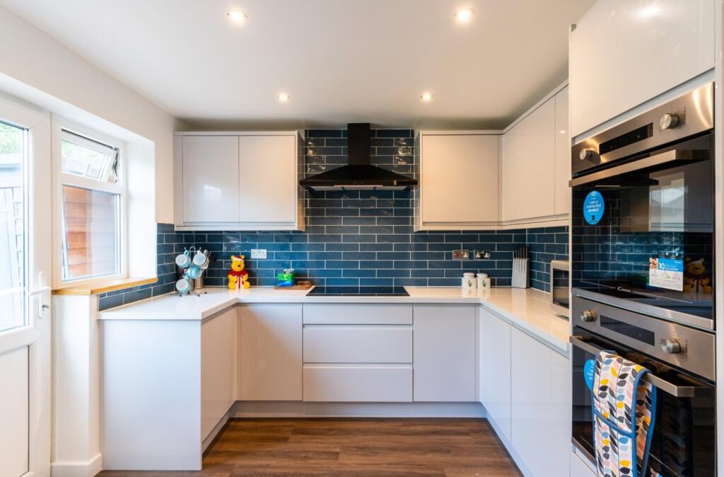 A modern and bright kitchen with sleek cabinetr...