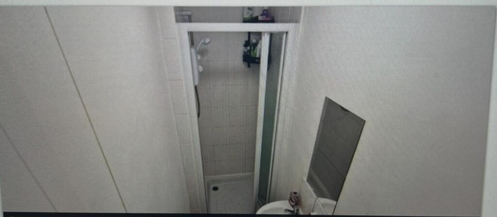 A compact and functional bathroom featuring a s...