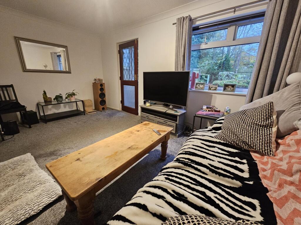 A cozy living room with a large window providin...