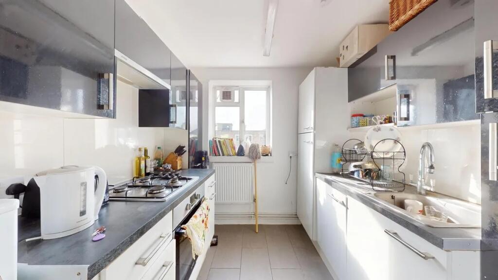 Bright and modern kitchen featuring sleek cabin...