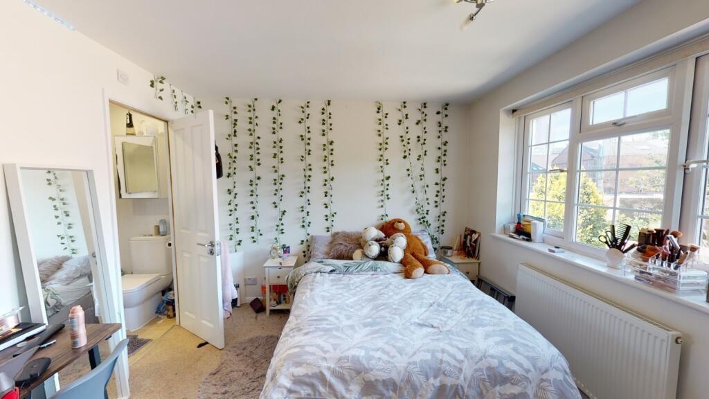 A bright and cozy double bedroom featuring a la...