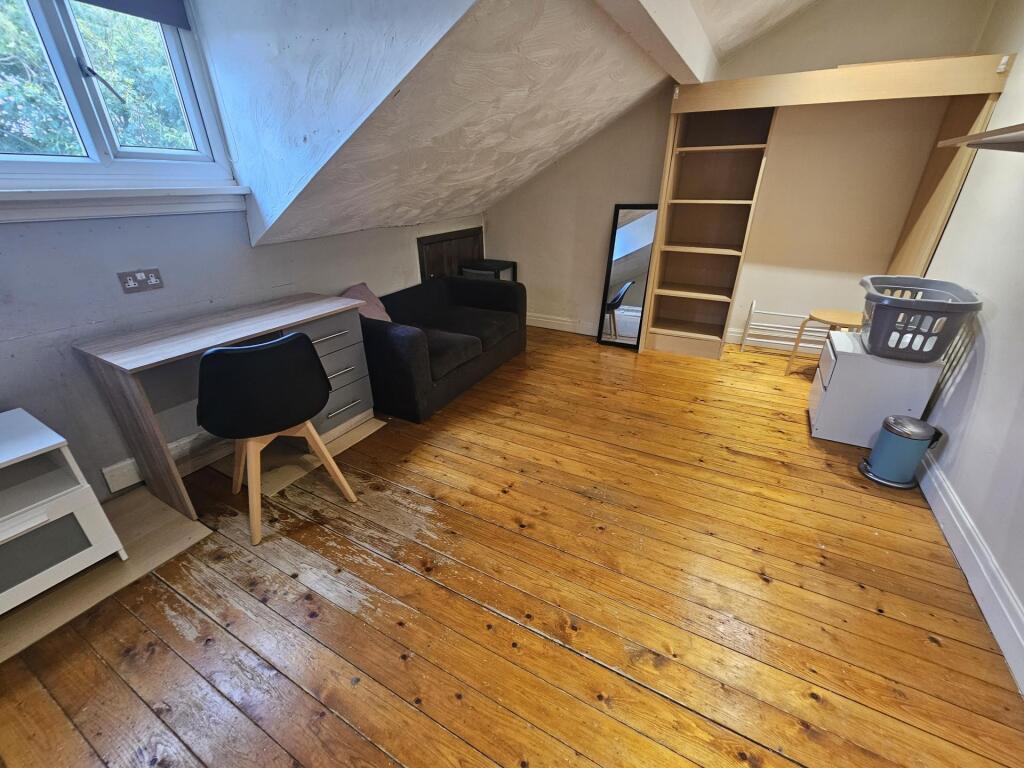 A bright and cozy living room with wooden floor...