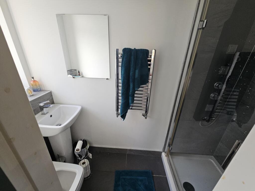 A well-maintained bathroom with a shower enclos...