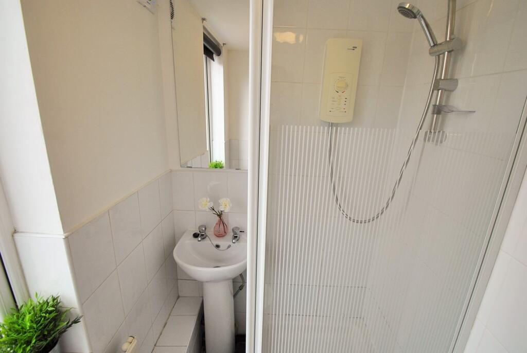 A modern bathroom featuring a sleek shower unit...