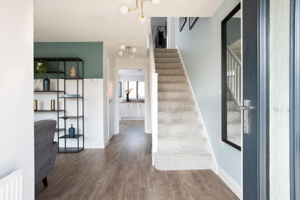 The entrance hall is flooded with natural light and there's space for understairs storage