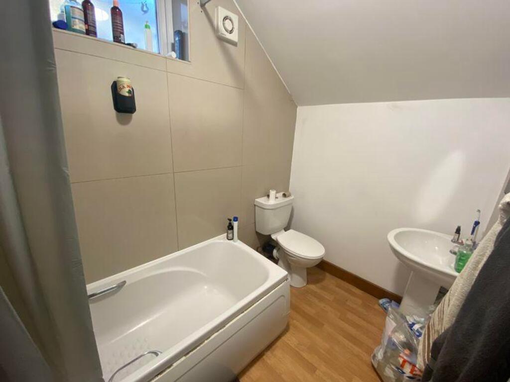 A tidy bathroom featuring a bath and essential ...