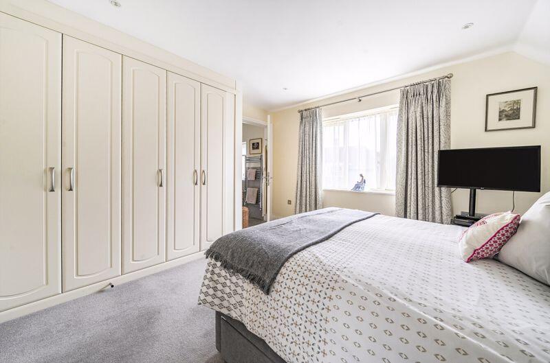 Master bedroom with fitted wardrobe a...