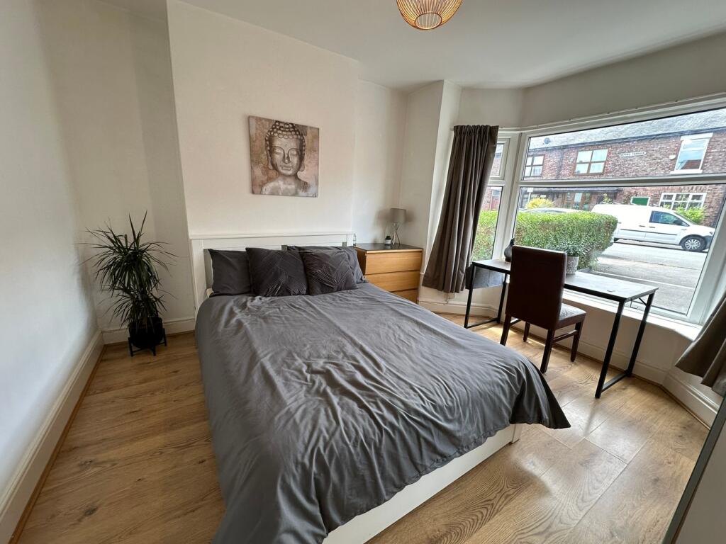 Bright and inviting double bedroom featuring la...