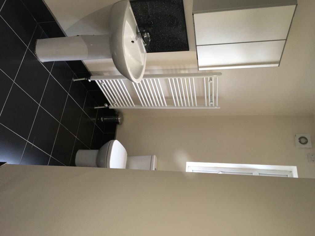 A modern bathroom suite featuring a clean white...